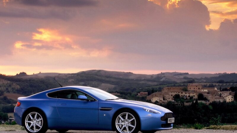 Blue sports car at sunset