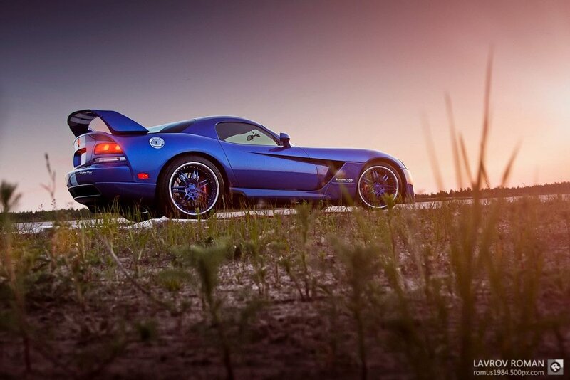 blue sports car at sunset