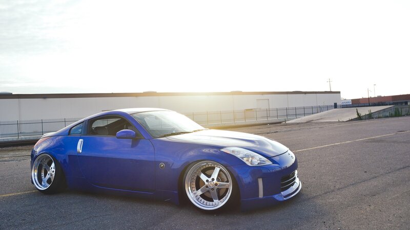 blue sports car at sunset