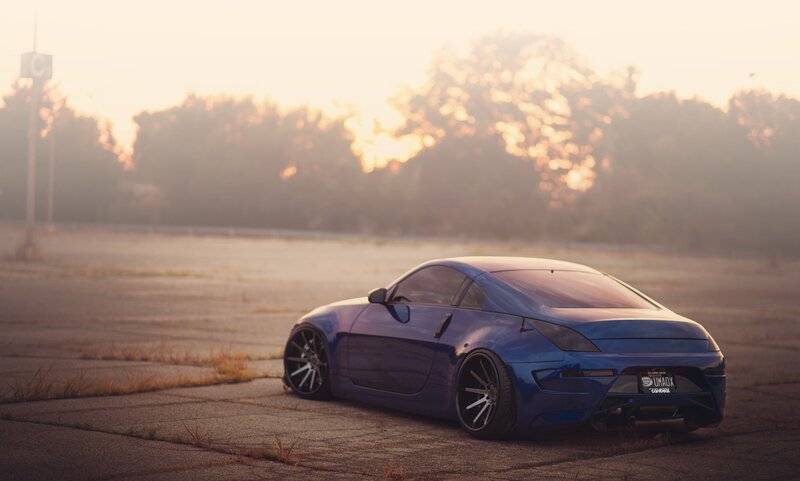 blue sports car at sunset
