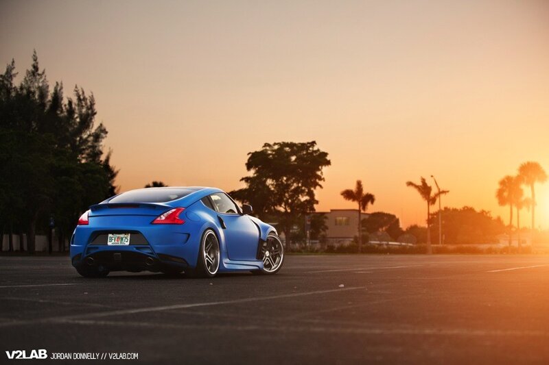 Blue sports car at sunset