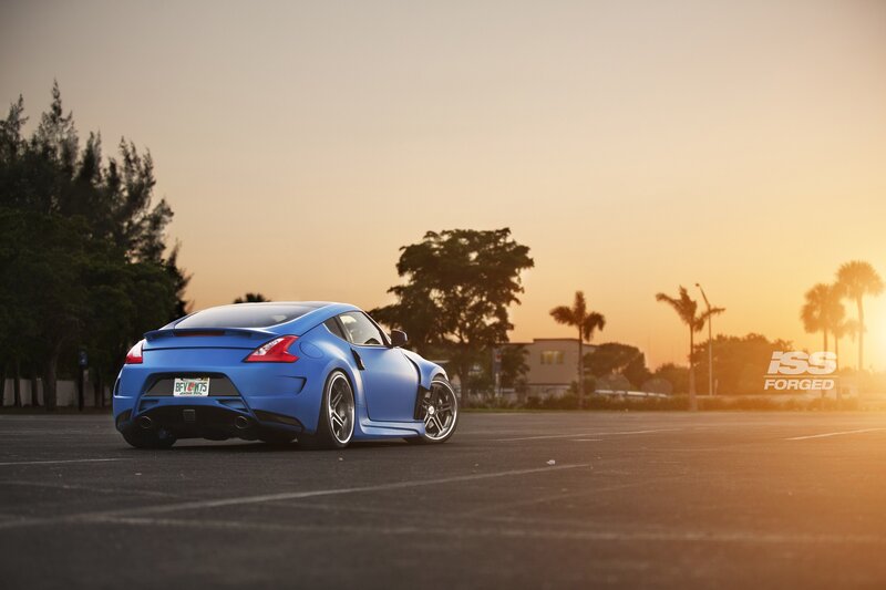 Blue sports car at sunset