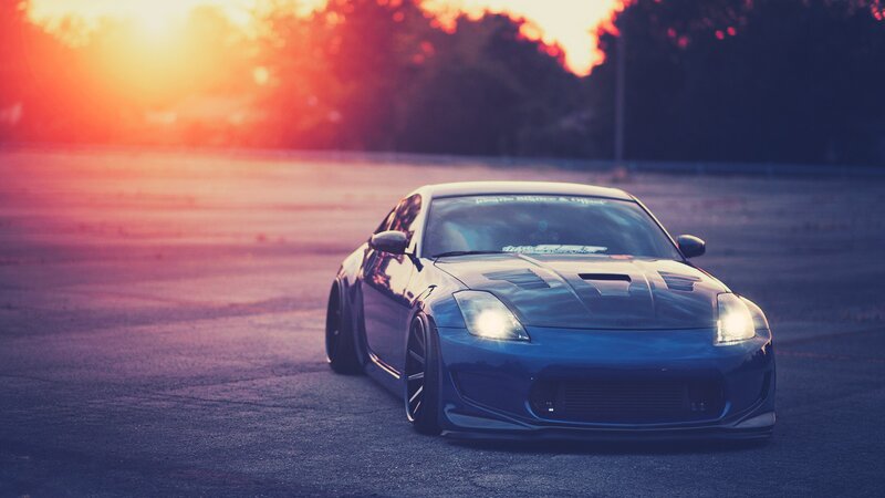 blue sports car at sunset