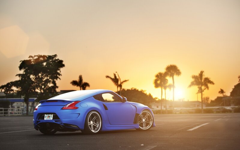 blue sports car at sunset