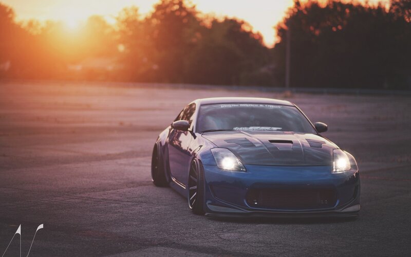 Blue sports car at sunset