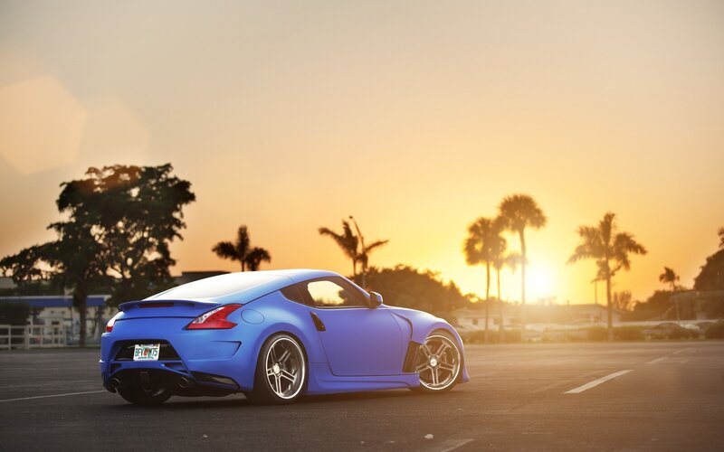blue sports car at sunset