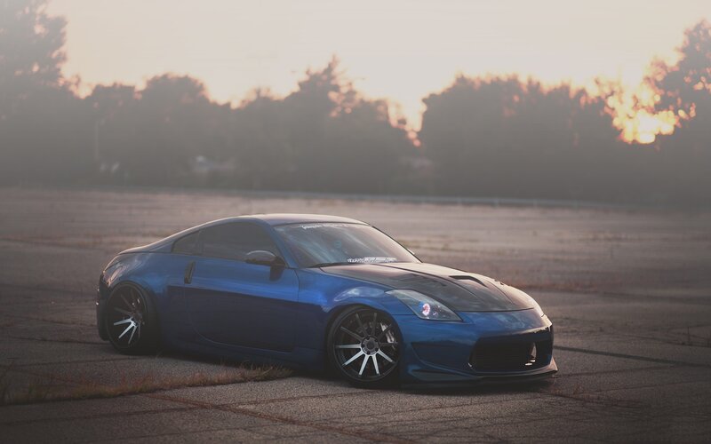 blue sports car at sunset