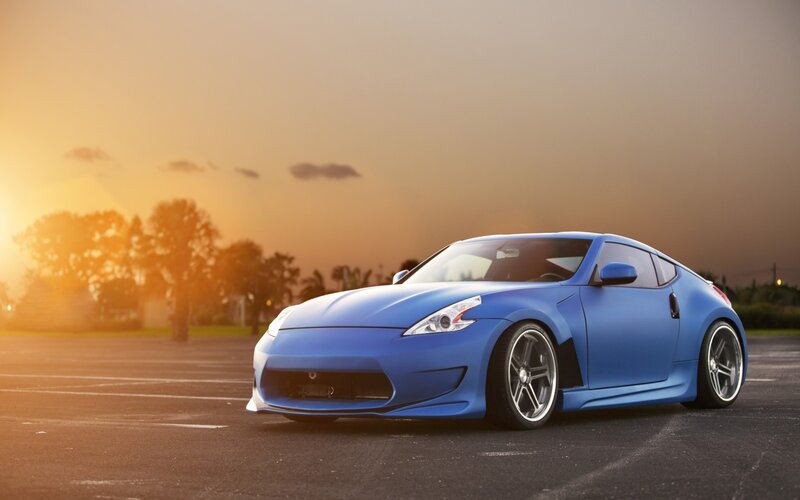Blue sports car at sunset