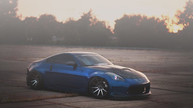 blue sports car at sunset