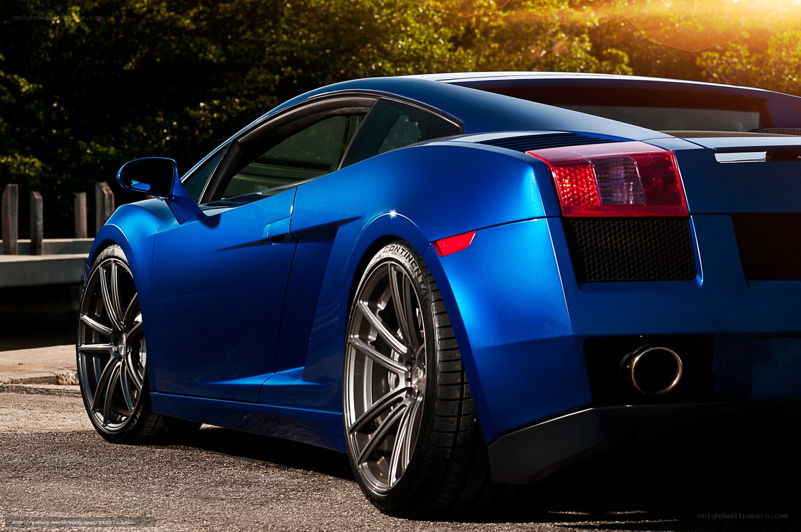 Blue sports car at sunset