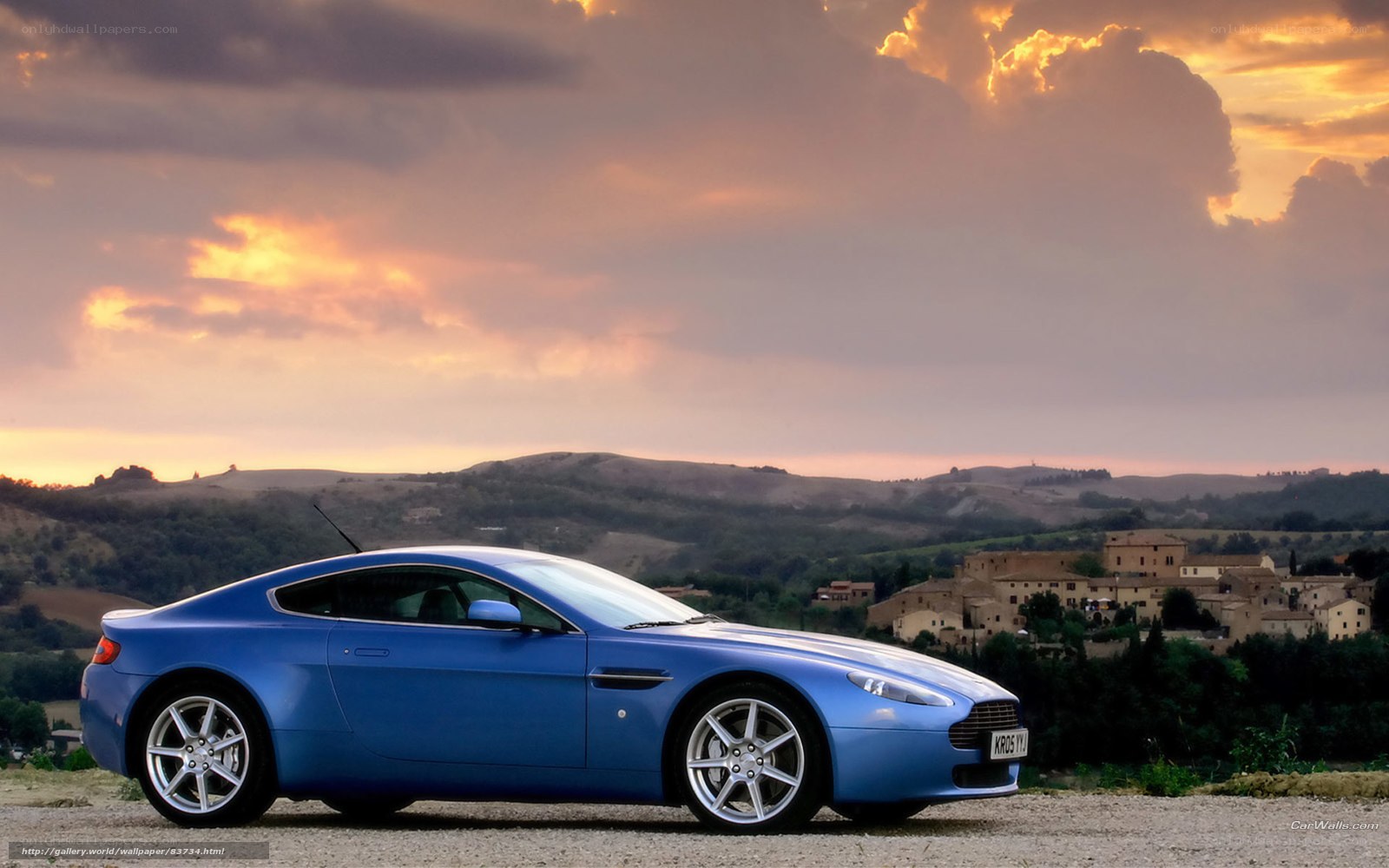 Blue sports car at sunset
