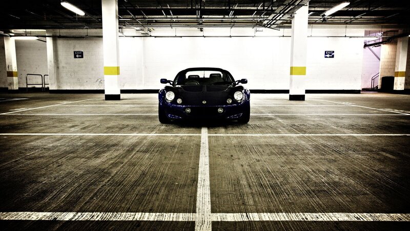Blue Sports Car — Black, Dramatic, Photograph, Parking Garage, White Lines