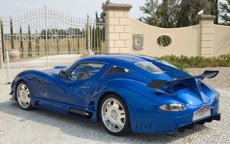 Blue Sports Car — Calm, Afternoon, Photograph, Gate, Wall