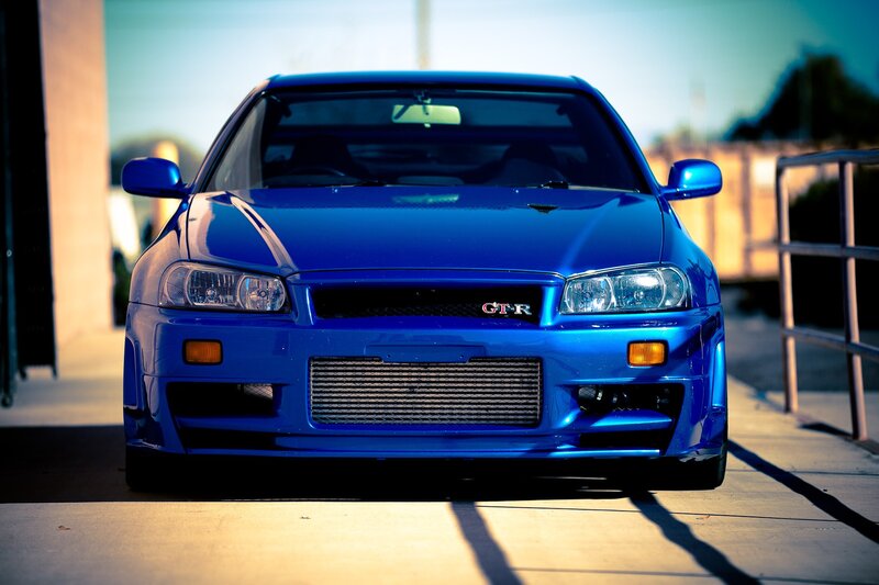 Blue Sports Car — Dramatic, Afternoon, Photograph, Grille, Headlights, Fence