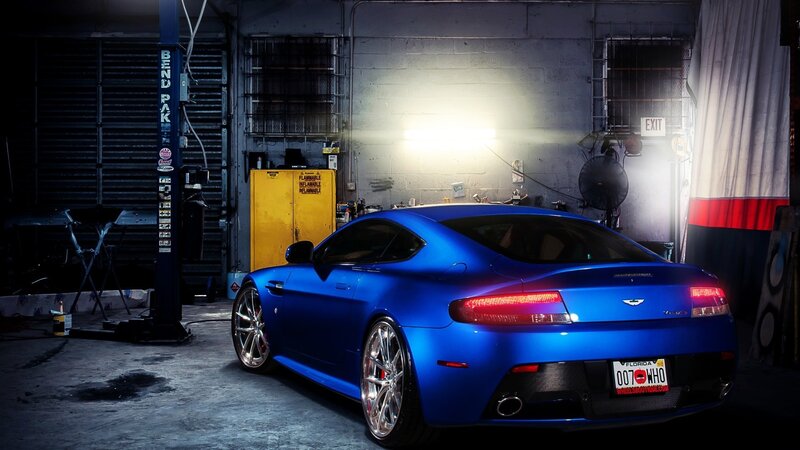 Blue Sports Car — Dramatic, Night, Photograph, Garage, Car Lift, Yellow Cabinet, Black, Gray