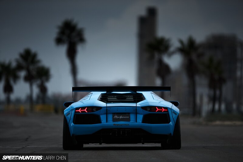 Blue Sports Car — Dramatic, Night, Photograph, Palm Trees, Tall Building