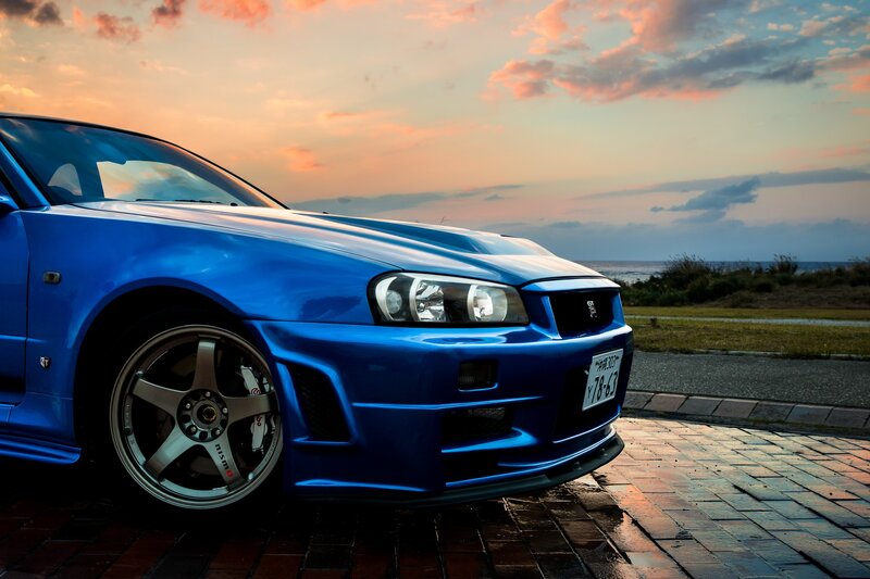 Blue Sports Car — Dramatic, Sunset, Photograph, Sky, Ocean