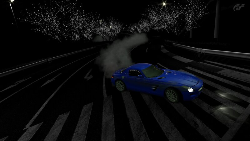 Blue sports car drifting at night