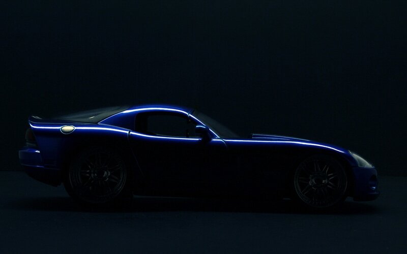 blue sports car in dark