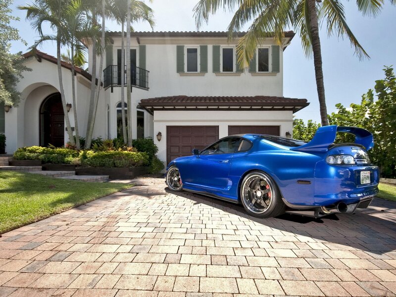 Blue sports car in driveway