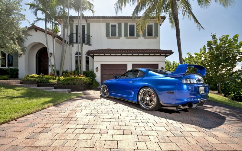 Blue sports car in driveway