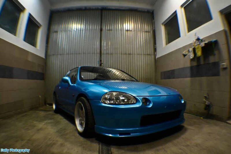 blue sports car in garage
