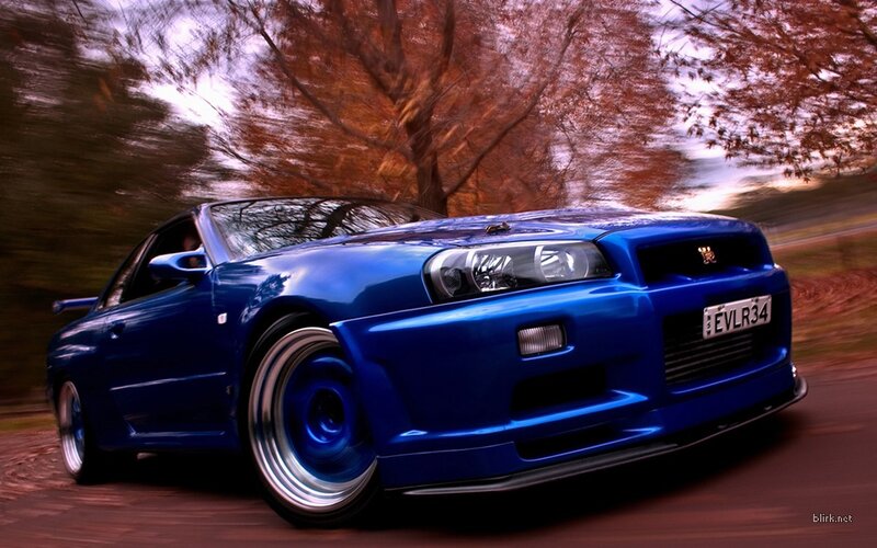 blue sports car in motion