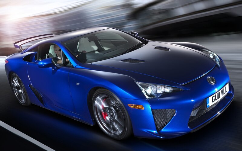 blue sports car in motion