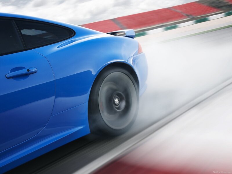 blue sports car in motion