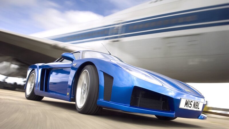blue sports car in motion