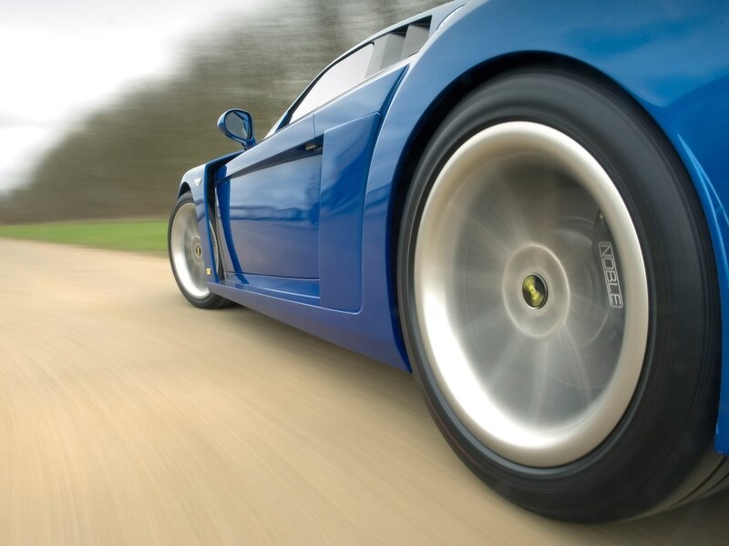 blue sports car in motion