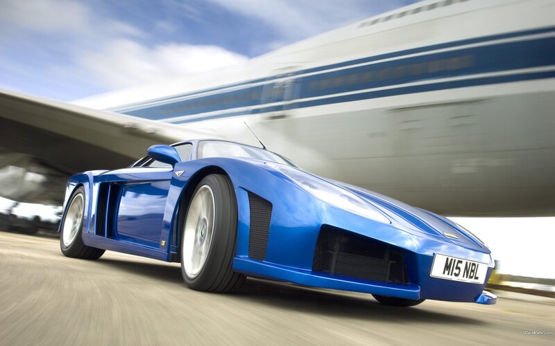 Blue sports car in motion