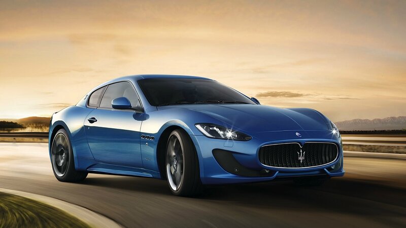 blue sports car in motion