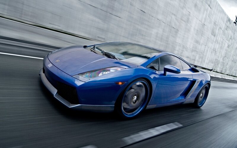 blue sports car in motion