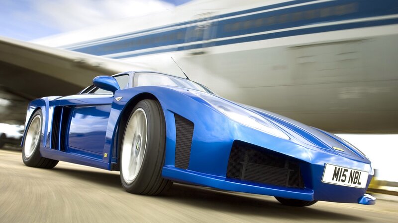 blue sports car in motion