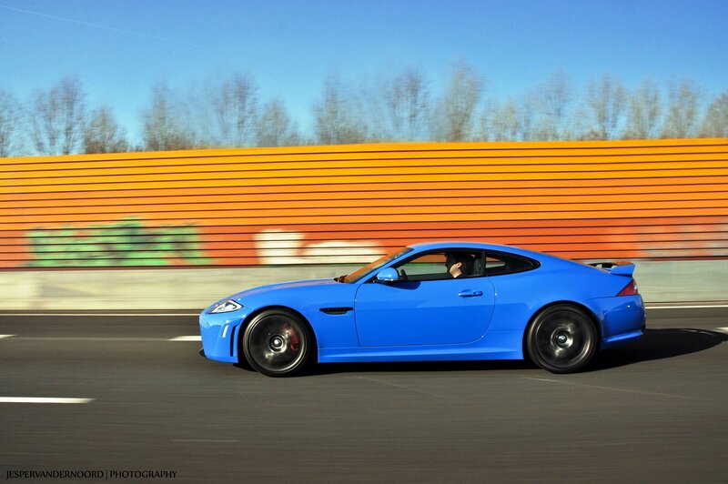 Blue sports car in motion