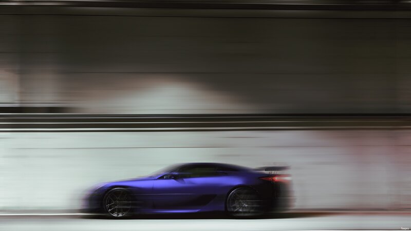 Blue sports car in motion