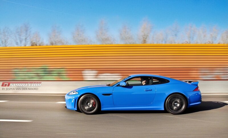 blue sports car in motion