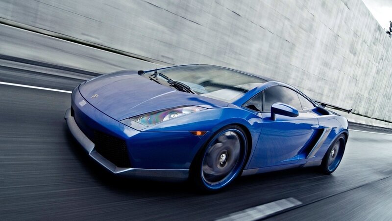 blue sports car in motion