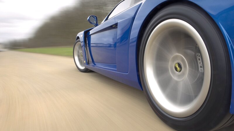 blue sports car in motion
