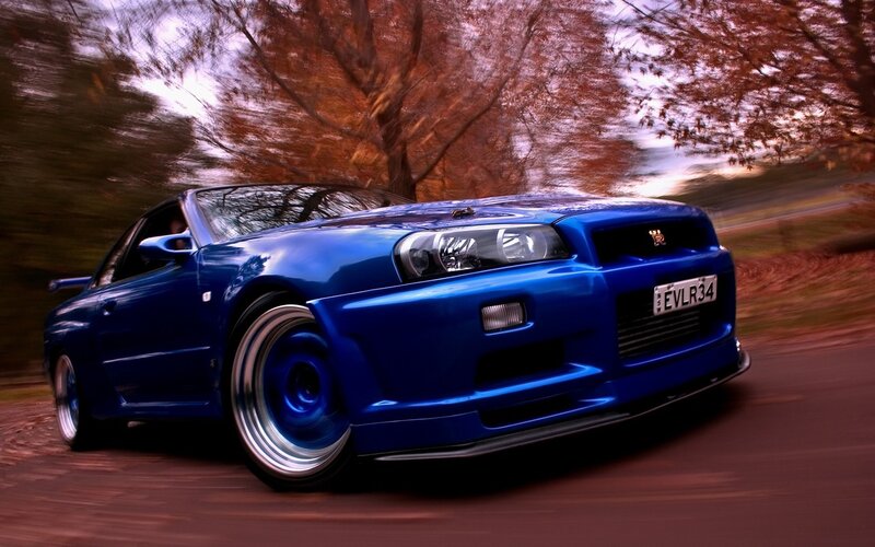 blue sports car in motion