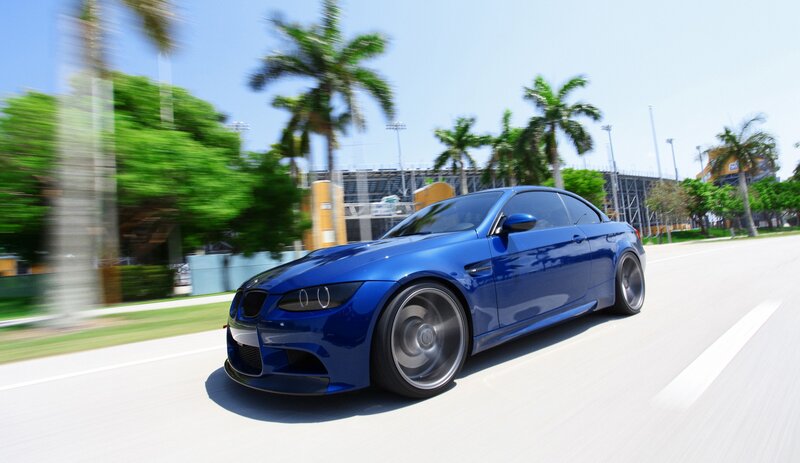 blue sports car in motion