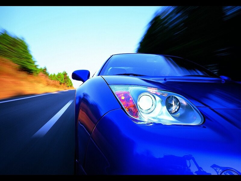 blue sports car in motion