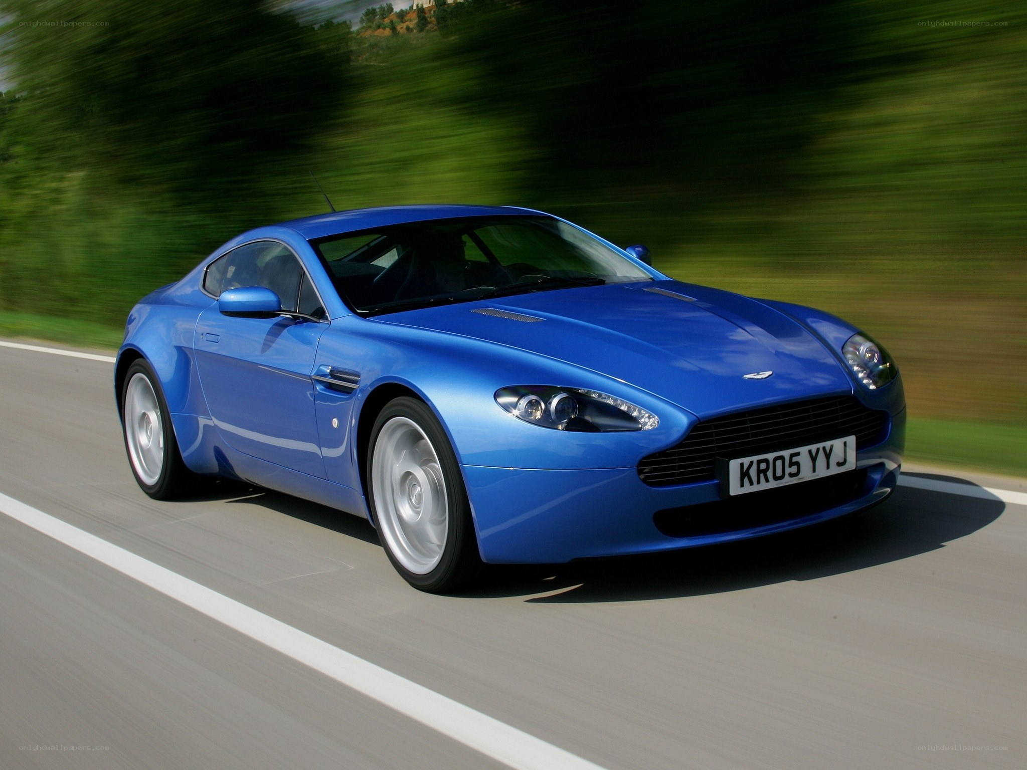 blue sports car in motion