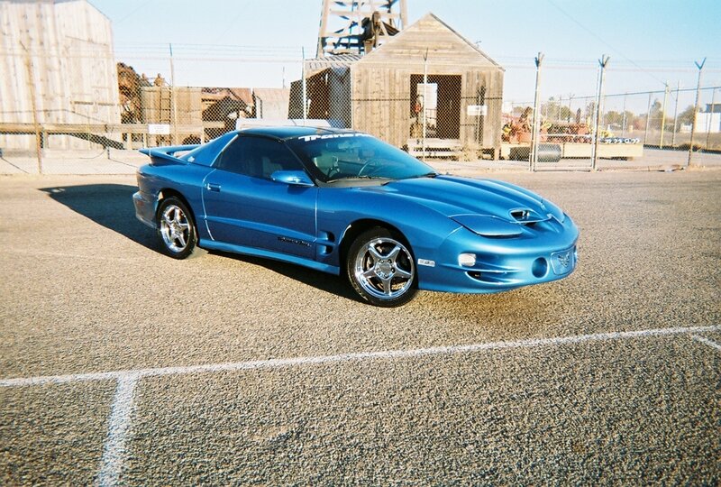 blue sports car in parking lot