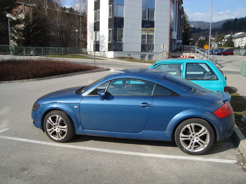 Blue sports car in parking lot