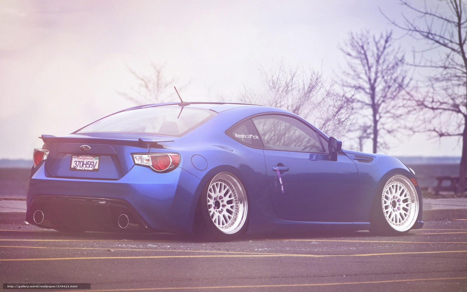 blue sports car in parking lot