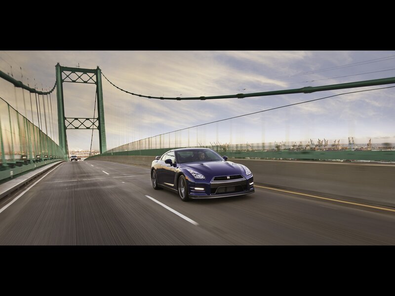 Blue sports car on a bridge