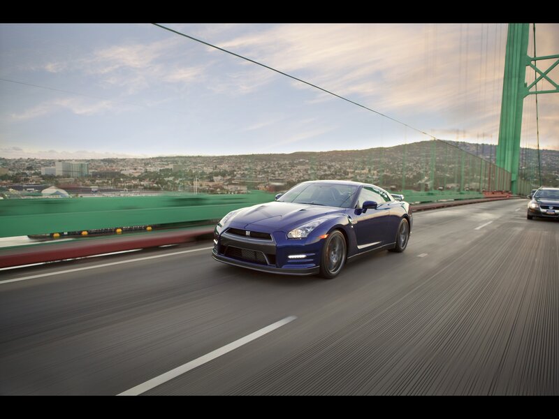 Blue sports car on a bridge