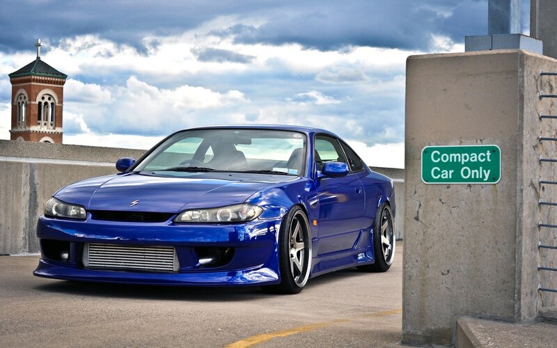 Blue sports car on a bridge